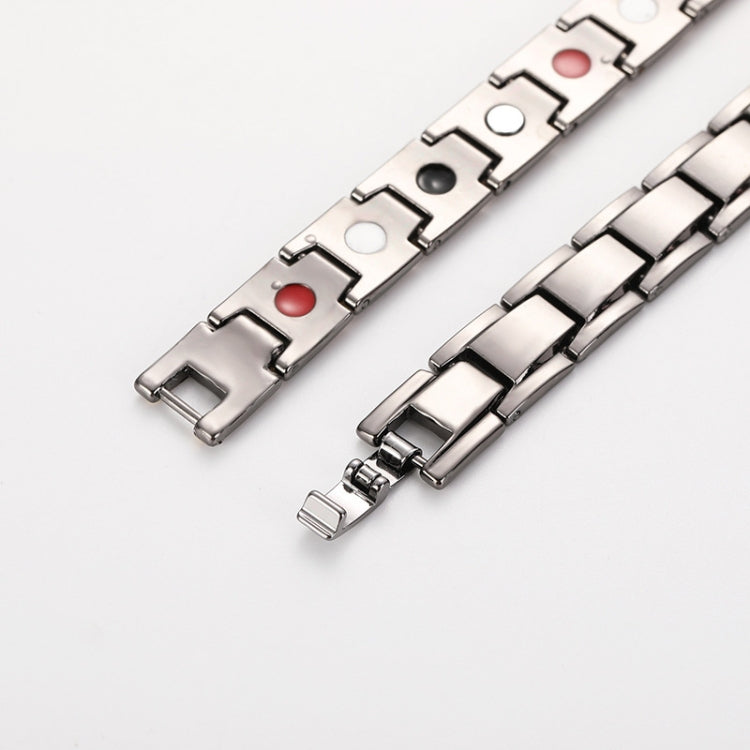 Men's titanium steel bracelet close-up of silver-tone links with red and black insets