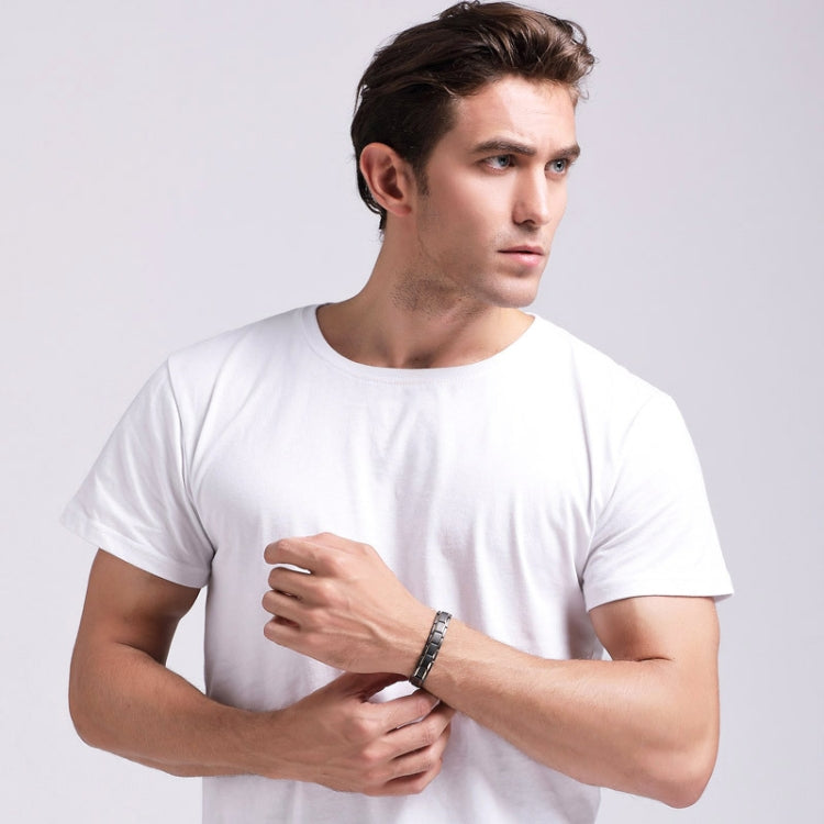 Men's magnetic bracelet on wrist with silver-tone metal links