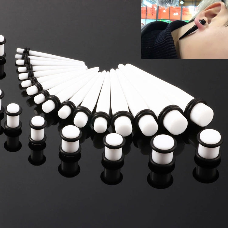 Unisex acrylic ear expansion set with white and black plugs and posts