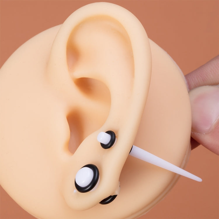 Unisex acrylic ear gauges in black and white on ear with insertion posts