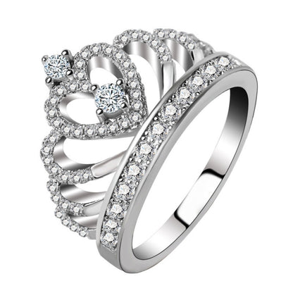 Crown-shaped zircon ring with round stones, platinum-plated look, side view.