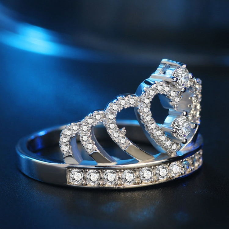 Platinum-plated crown ring with heart cutout and border of sparkling zircon stones
