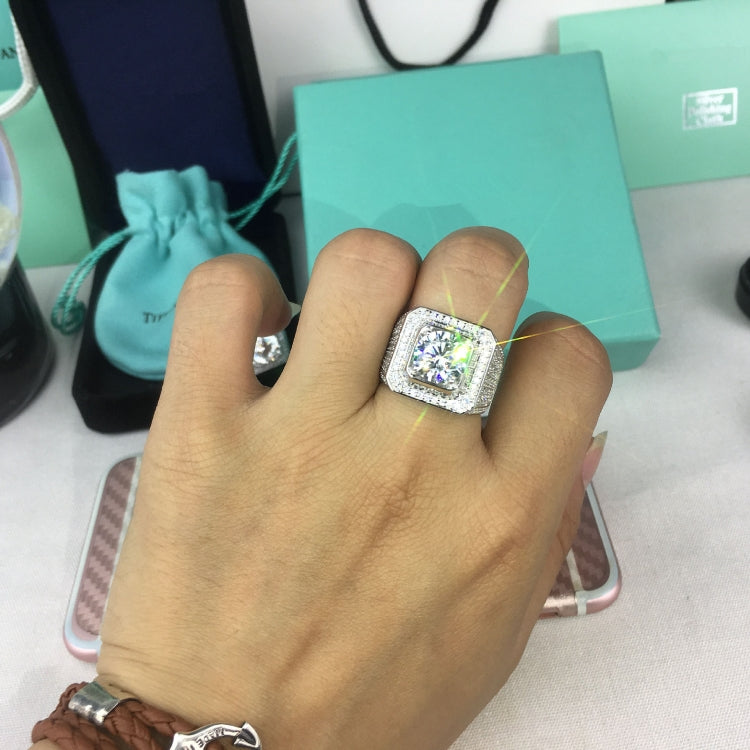 Silver rhinestone square ring worn on a hand, center stone visible
