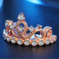 Rose gold crown-shaped zircon ring with central oval cutout and round stones