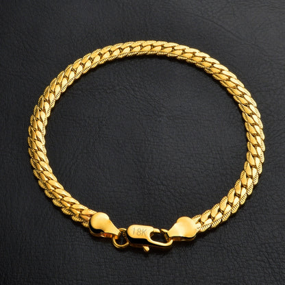 18k yellow gold bracelet with braided chain and heart-shaped clasp, center tag detail