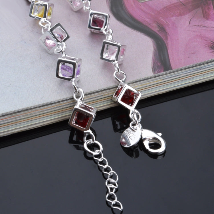 Silver bracelet with dangling multicolor hollow square rhinestone links and toggle clasp.
