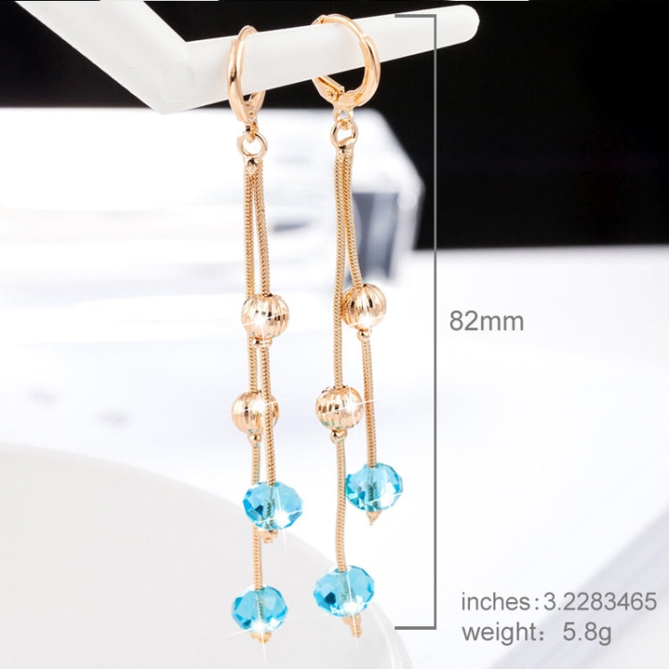 Long gold-tone crystal tassel earrings with blue drop beads