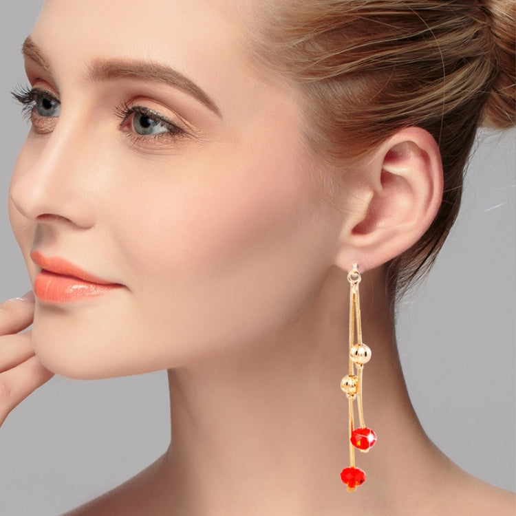 Gold-tone crystal tassel earrings with red drop beads and clear accents