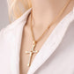 Gold rhinestone cross pendant necklace close-up at the collar