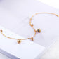 Gold-plated bracelet with blue zircon round bead and dangling pendant charms