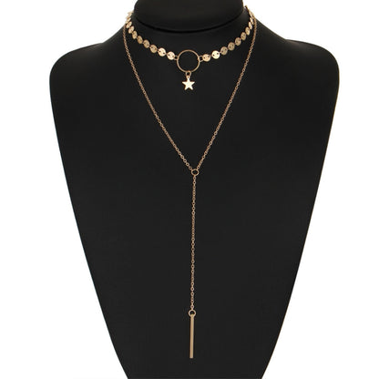 Gold double-layer necklace with star charm and long bar tassel on oval links