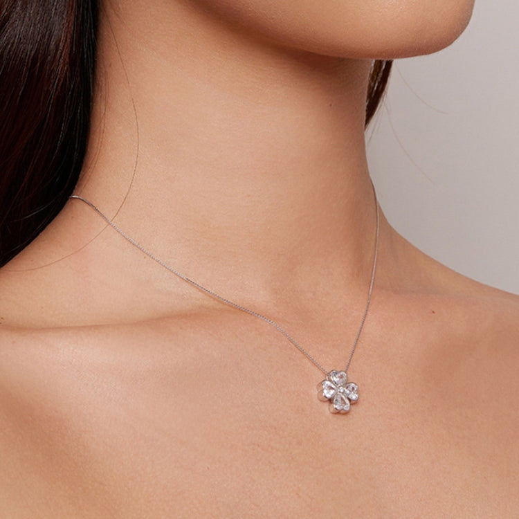 Lucky clover pendant necklace worn on the neck with four petal stones and center stone