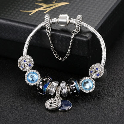 Silver-tone beaded charm bracelet with blue moon and star accents, linked bracelet design