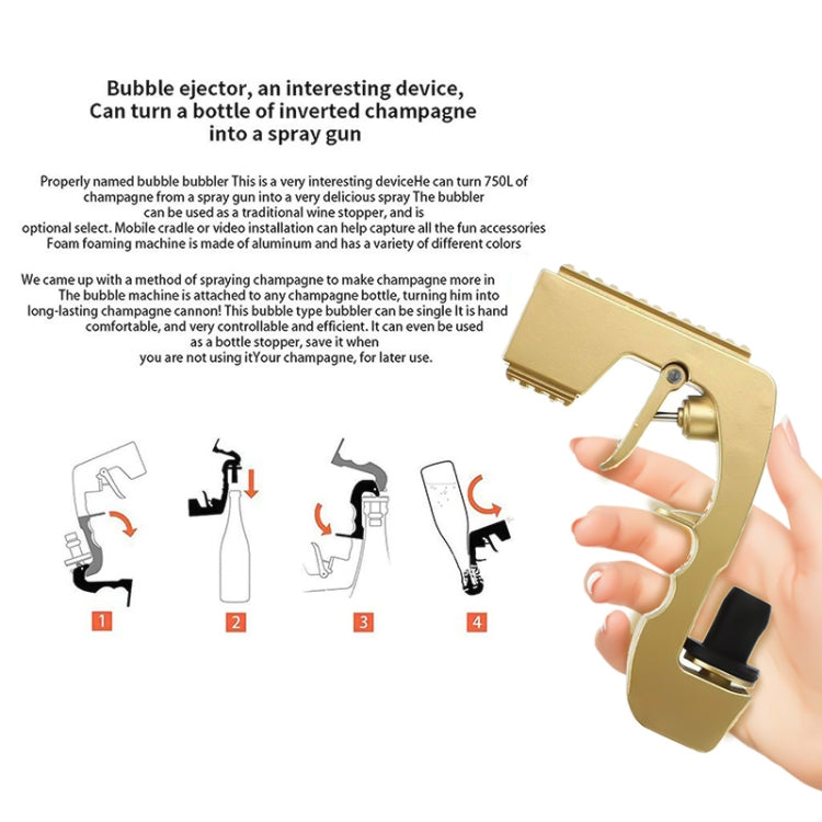 Gold bubble squirt gun held in hand with nozzle pointed forward