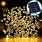 Solar LED string lights with warm golden round bulbs and black solar panel for outdoor use