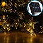 Solar-powered star LED string lights with warm yellow glowing star bulbs and solar panel