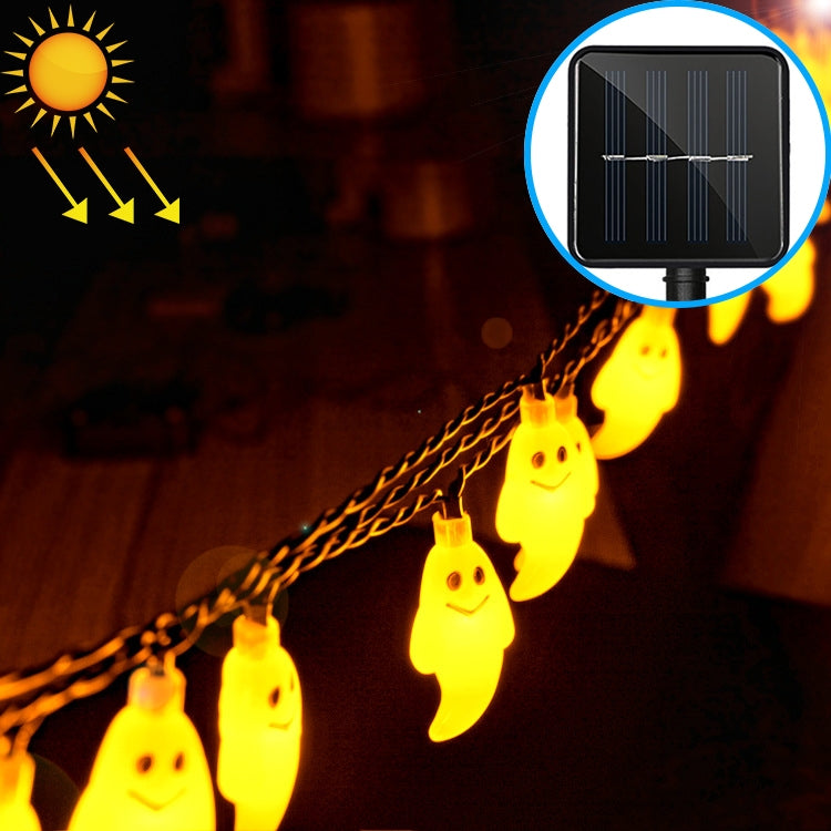 Warm yellow-glowing ghost-shaped LED string lights on an outdoor cord