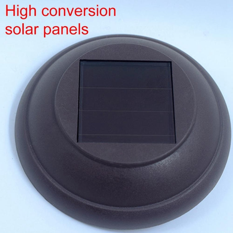 Solar garden stake lamp solar panel under round dark cover