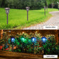 Set of solar stake lantern lights along a walkway edge