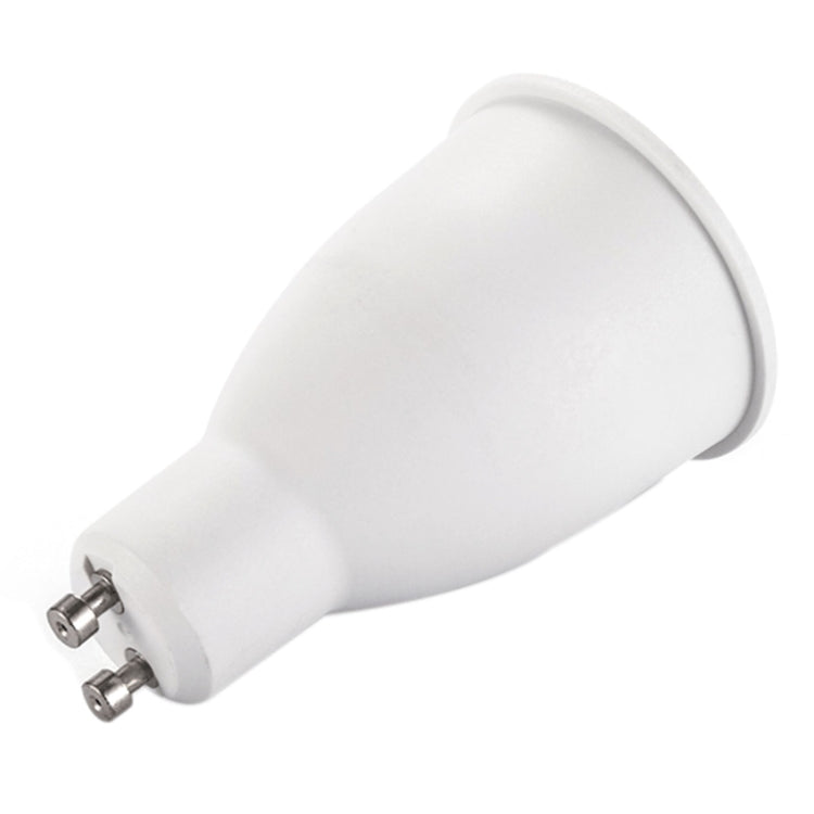 Warm white GU10 LED spotlight bulb, side view with screw pins on white base