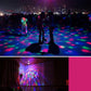 Multicolor rotating LED light patterns across dance floor and indoor ceiling