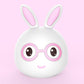 White bunny LED lamp with pink inner ears and pink glasses, smiling face