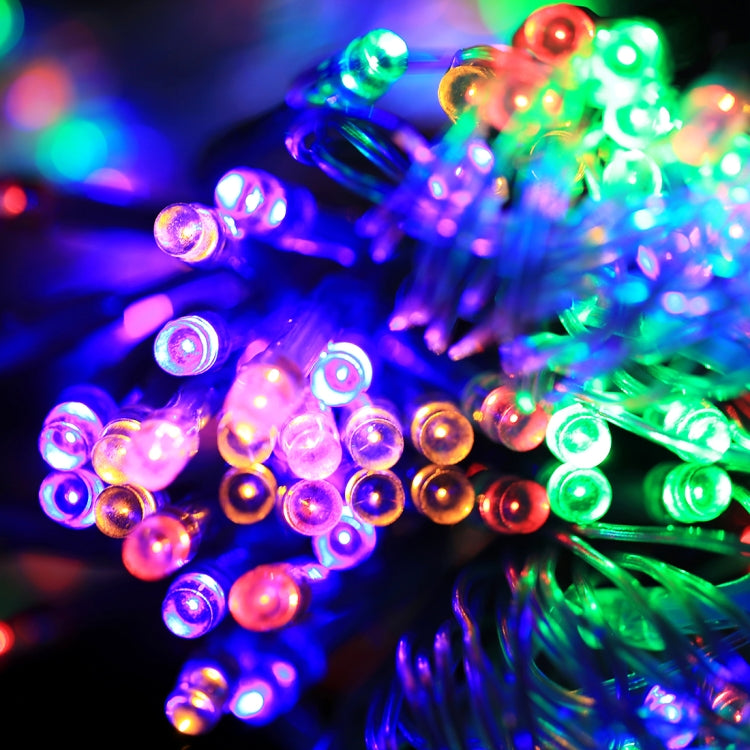 Colorful LED string light bulbs glowing in multicolor on clear wire