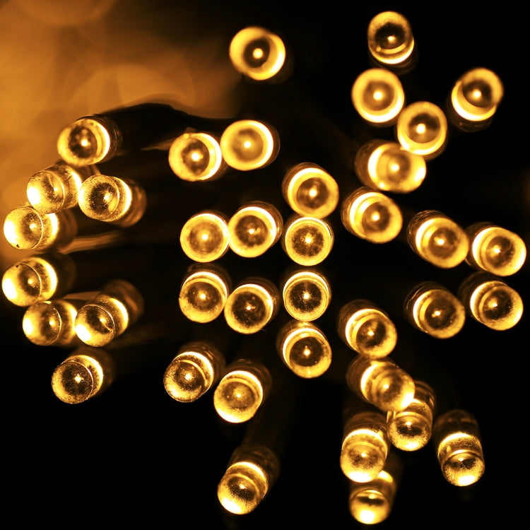 Warm white LED string light bulbs glowing with round caps on cable