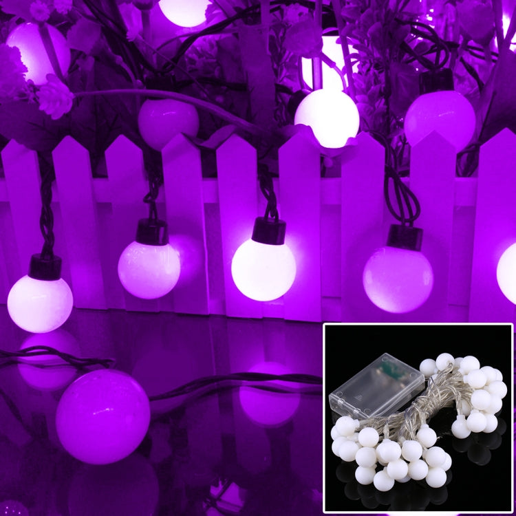 Purple LED globe string lights with round lit bulbs on a hanging strand