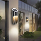 Solar LED induction wall light, black and silver body with warm glow