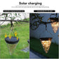Set of hanging solar garden lamps with clear cones and glowing warm light