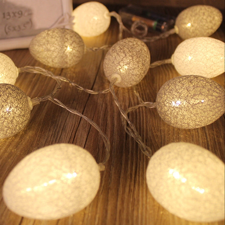 Light gray and white cotton egg string lights with round textured fabric bulbs