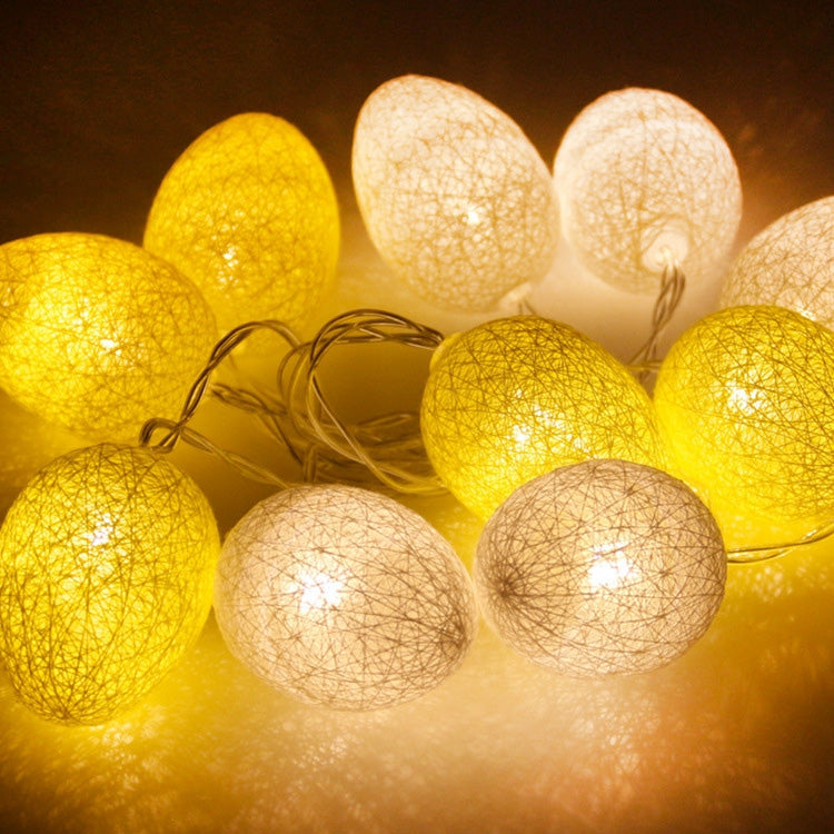 Glowing yellow and warm white egg light string with cotton-thread globe bulbs
