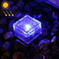 Solar LED buried light cube with blue glow through clear textured glass