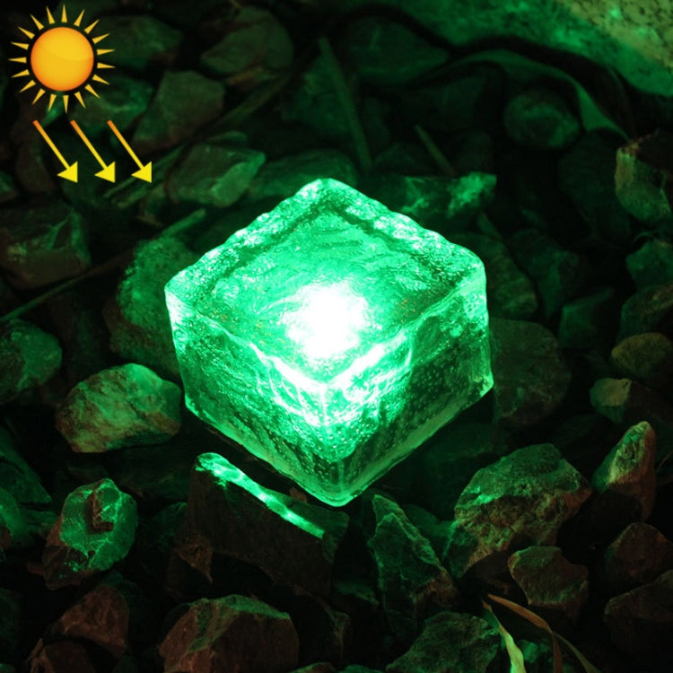 Solar LED buried light cube with green glow through clear textured glass