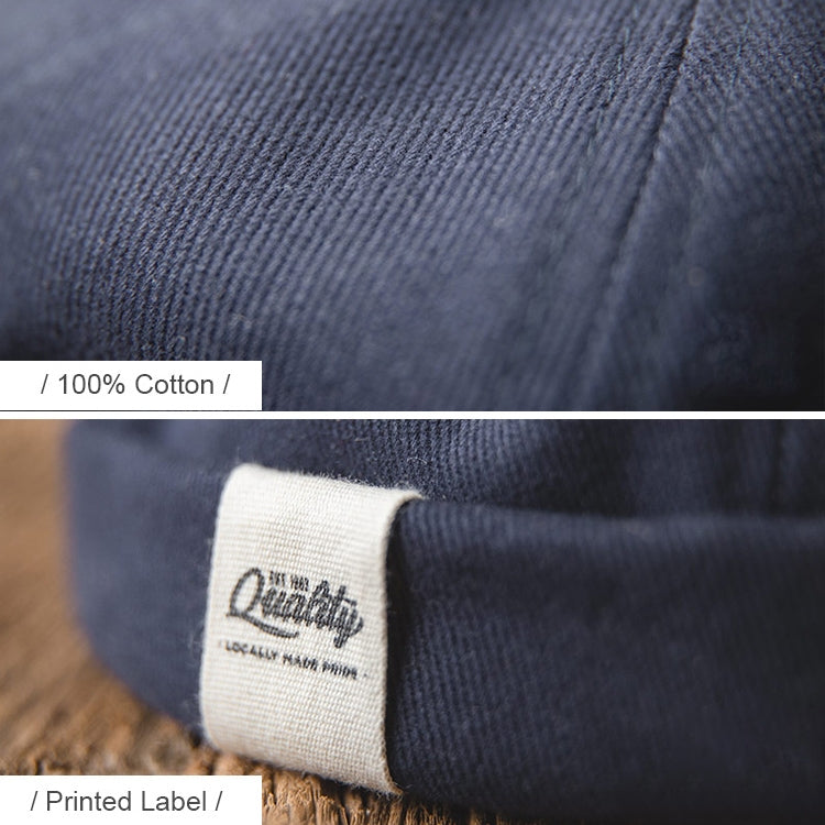 Navy knit beanie hat close-up with cuff edge and white printed label