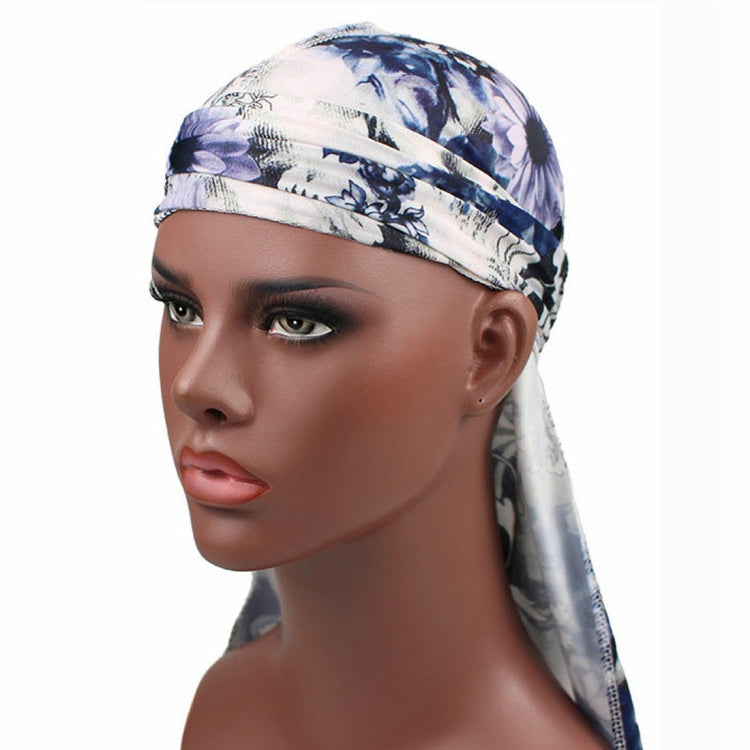 Long-tailed pirate hat headscarf with blue and white floral print, banded crown and drape