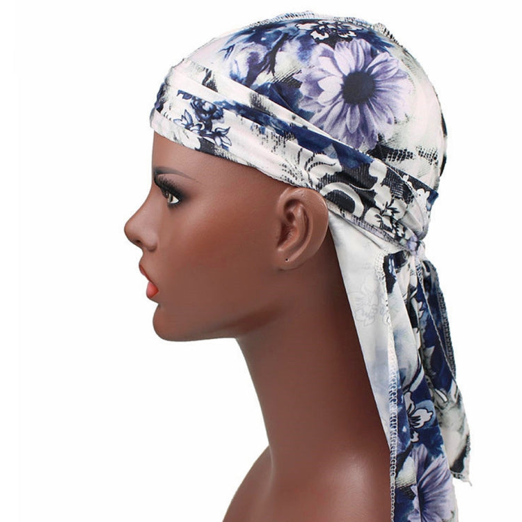 Long-tailed pirate hat headscarf in blue-and-white floral print, side profile long tails