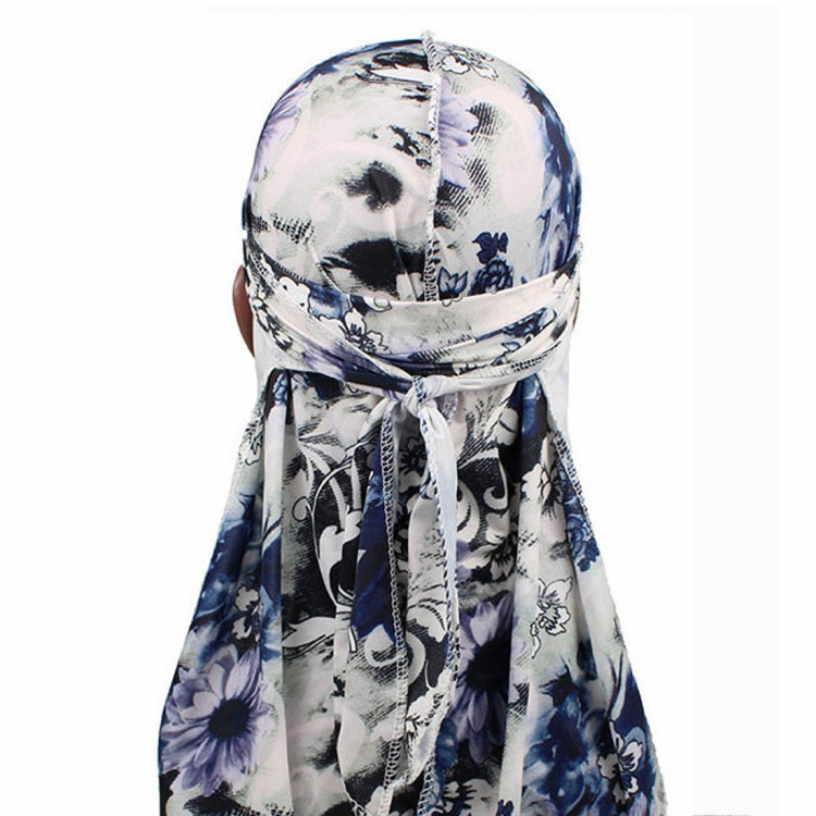 Long-tailed pirate hat headscarf with blue floral print and long hanging tails