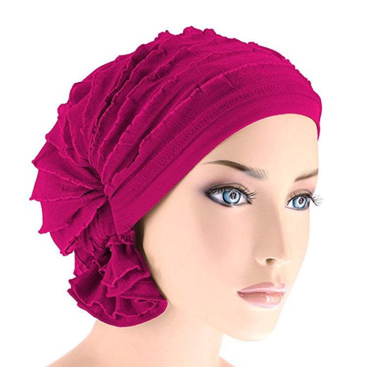 Fuchsia chiffon fold turban cap with stacked ridges and ruffled side flower