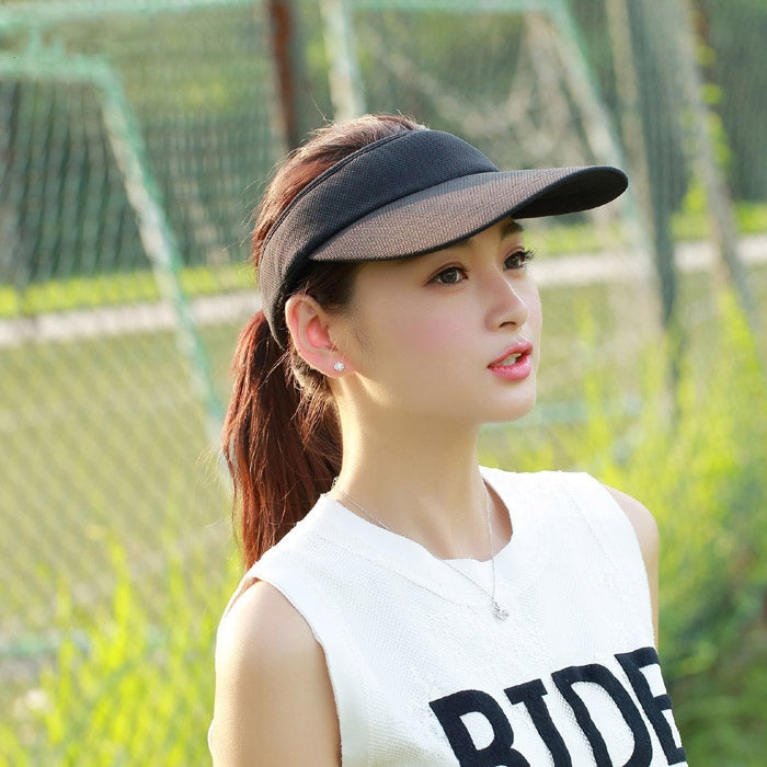 Black visor cap with curved brim and breathable textured fabric for outdoor wear.