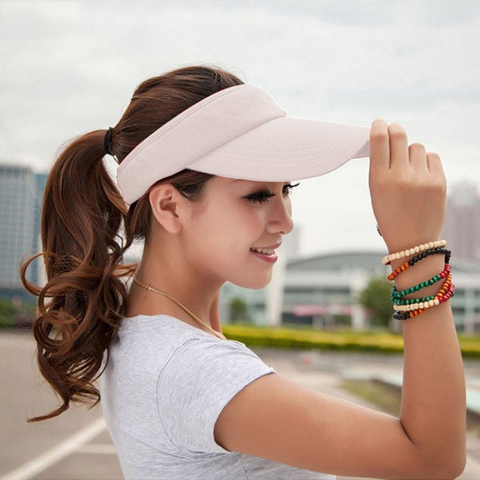 Light beige visor cap with curved brim and breathable textured fabric top.