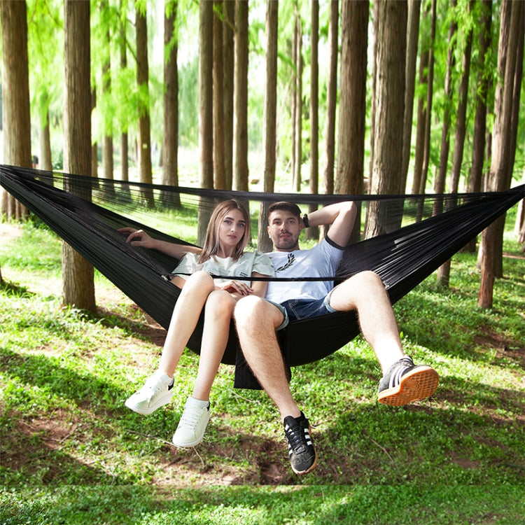 Black parachute hammock sling with two people relaxing outdoors