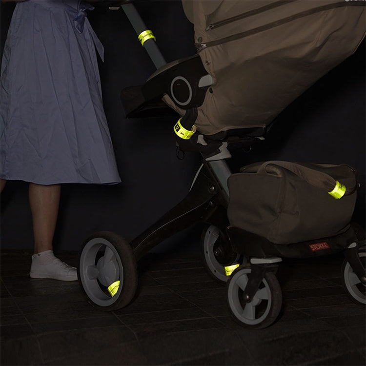 Reflective wristbands on stroller straps, neon green