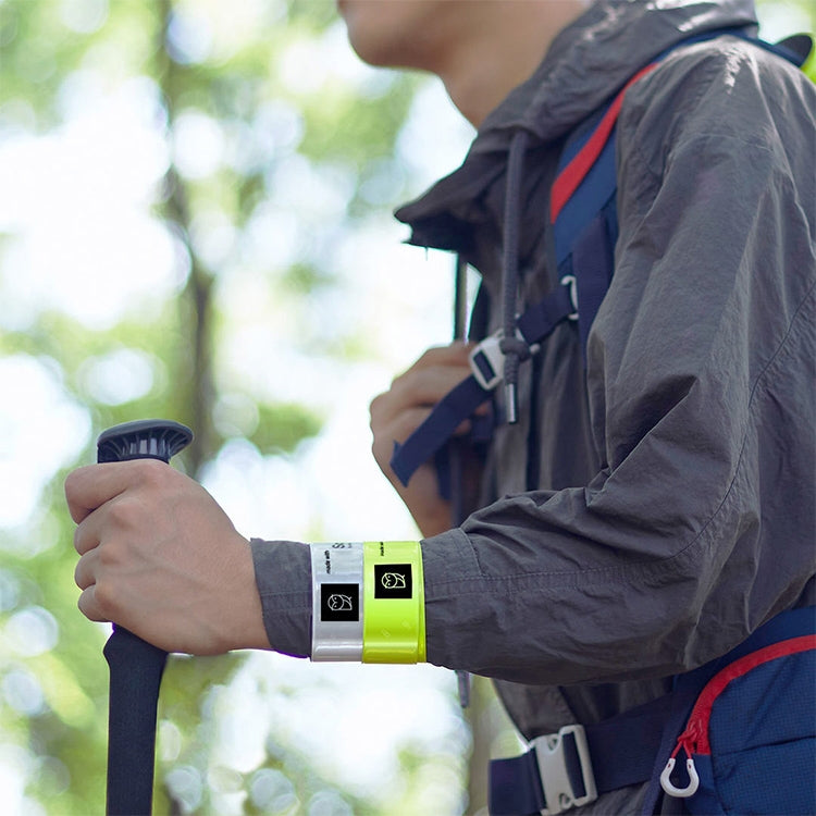 Reflective wristband on adult wrist over dark jacket sleeve