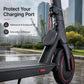 Black silicone charging port cover attached to scooter frame with tether loop
