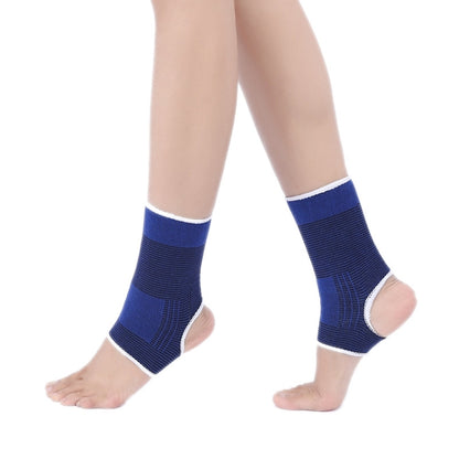 Royal blue elastic ankle support guards with white trim, on both feet
