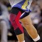 Red and black knee brace with textured mesh panel over the knee.