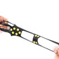 Black ice traction shoe cover with yellow studs, held by hands