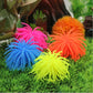 Assorted colorful spiky sea urchin ball coral decorations arranged on aquarium grass